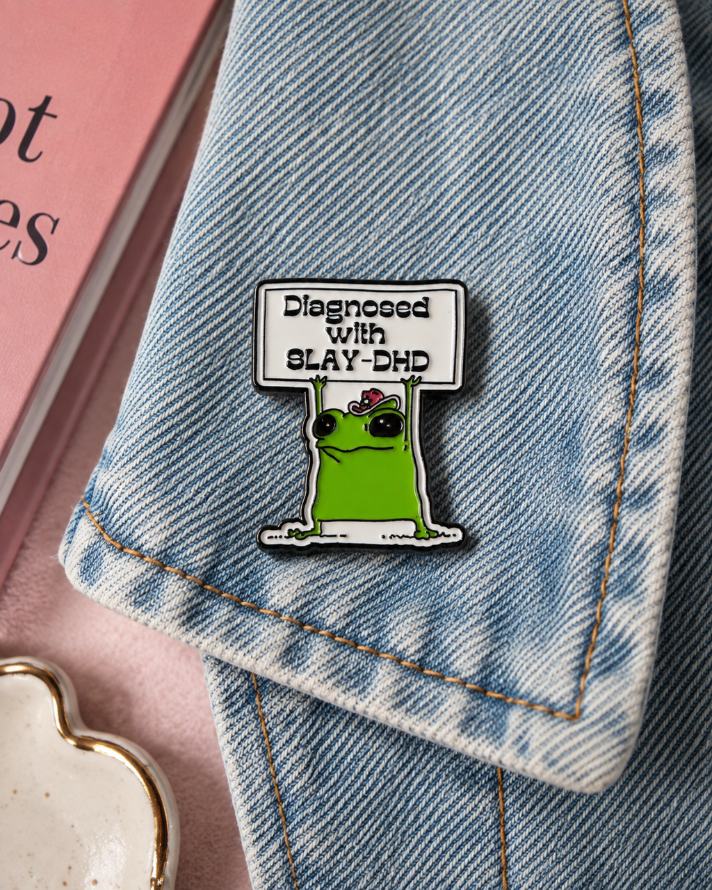 Diagnosed with Slay-DHD enamel pin on denim