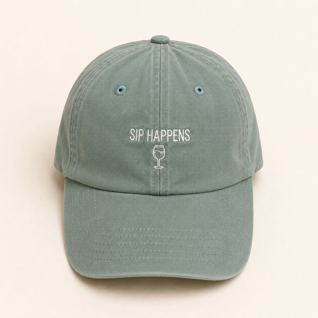 Green cap with 'SIP HAPPENS' text on a beige background